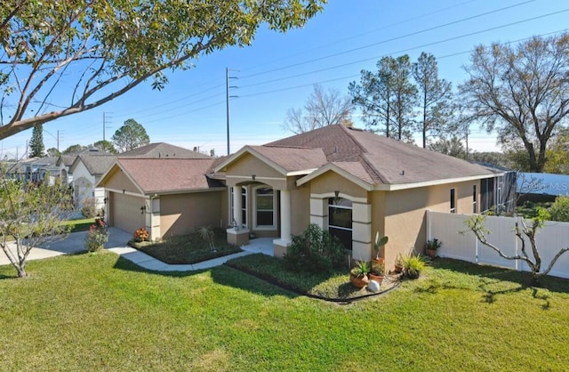 single story home with a garage and a front lawn