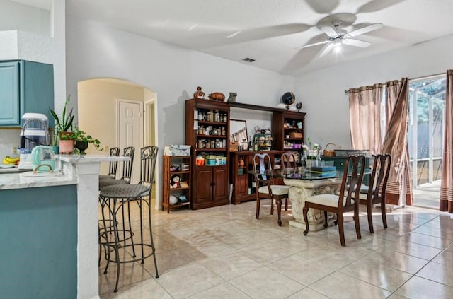 dining space with ceiling fan and light tile patterned flooring