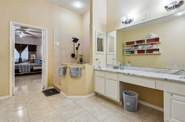 bathroom with vanity, ceiling fan, tile patterned flooring, and a textured ceiling