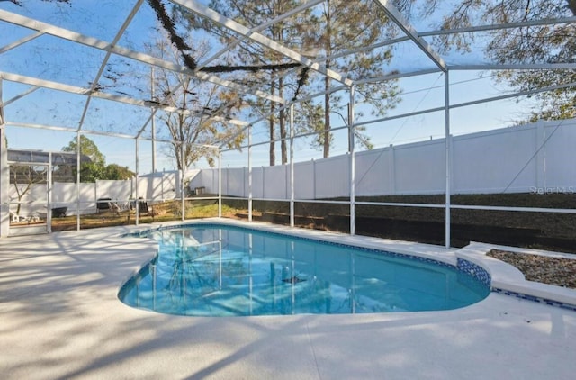 view of pool with a lanai and a patio