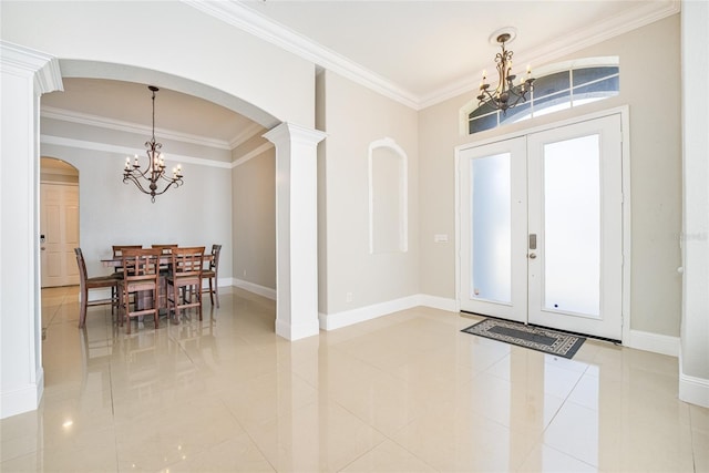 entrance foyer featuring a notable chandelier, ornamental molding, and french doors