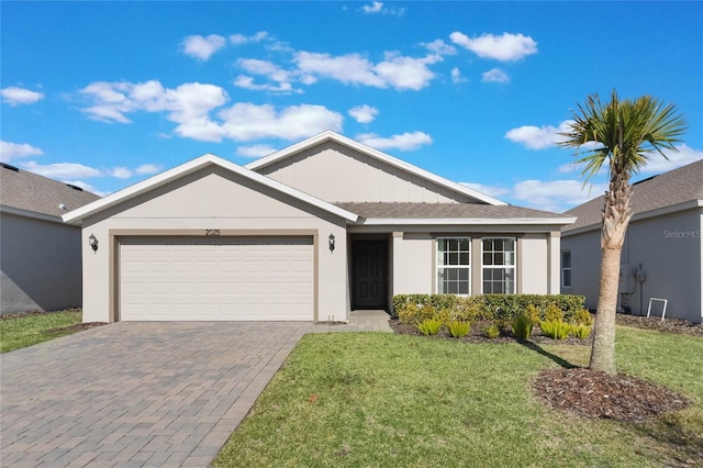 single story home featuring a garage and a front lawn