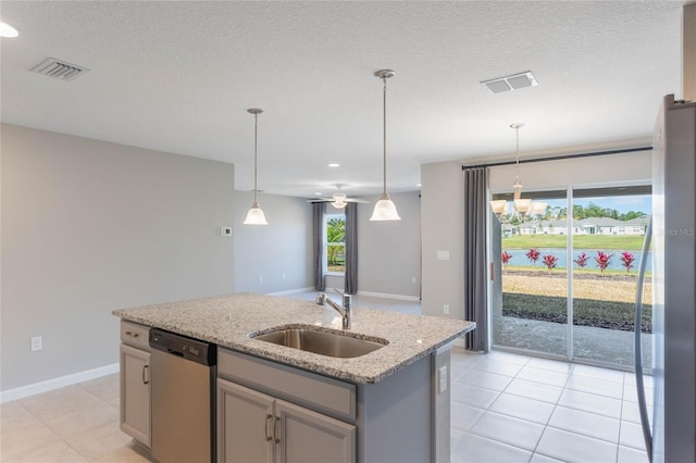 kitchen with sink, gray cabinetry, light stone counters, an island with sink, and stainless steel dishwasher