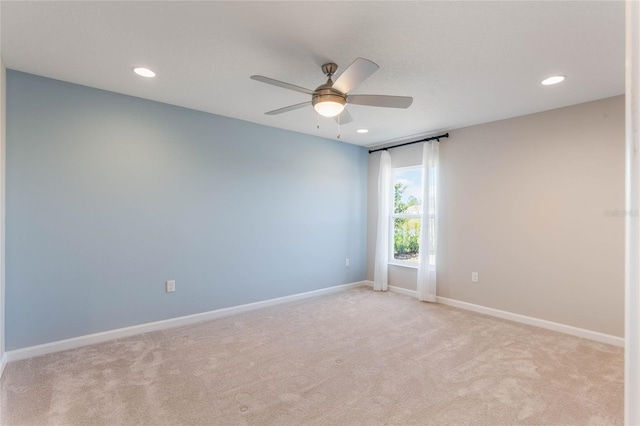 carpeted spare room with ceiling fan