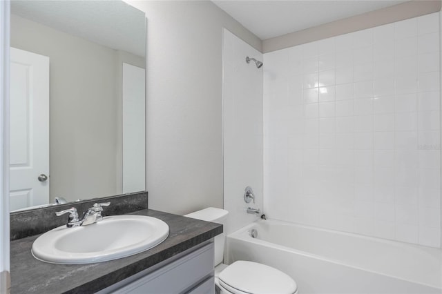 full bathroom with vanity, tiled shower / bath combo, and toilet