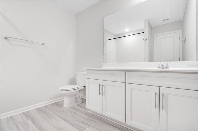 332 Bow Ln, Haines City, FL 33844 - bathroom featuring toilet, visible vents, vanity, baseboards, and wood tiled floor