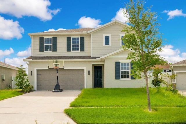 view of front of home with a garage, driveway, and a front lawn