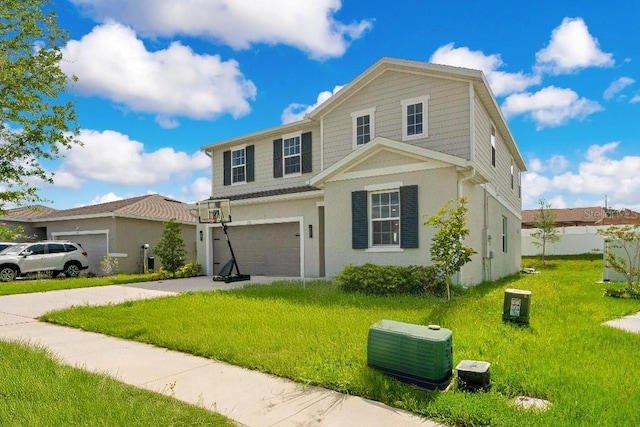 view of front of property featuring a garage, driveway, and a front lawn