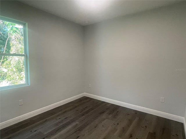 unfurnished room featuring dark hardwood / wood-style flooring