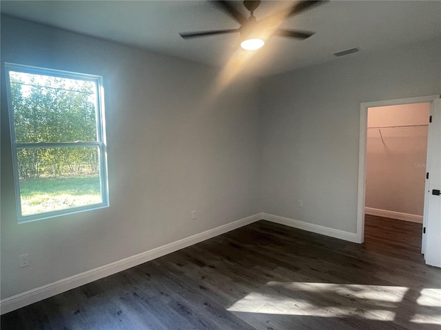 spare room with ceiling fan and dark hardwood / wood-style flooring