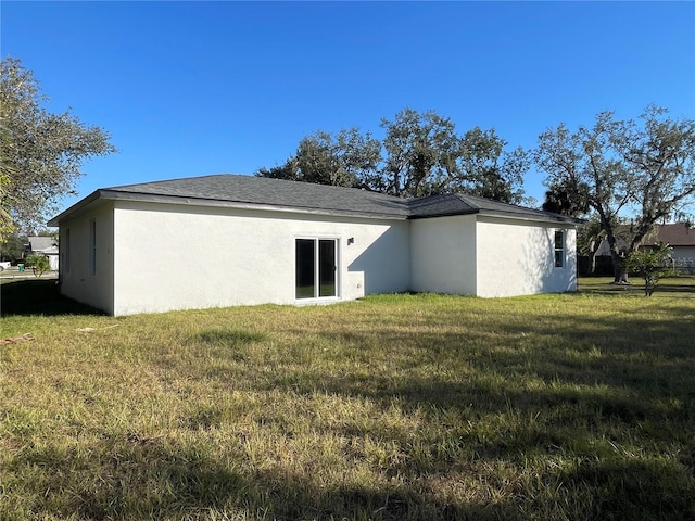 rear view of house with a yard