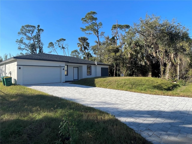 ranch-style home with a garage and a front yard