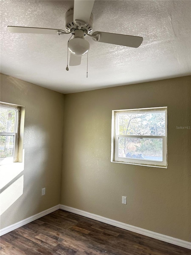 spare room with dark hardwood / wood-style flooring and ceiling fan