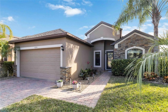 view of front of home with a garage and a front lawn