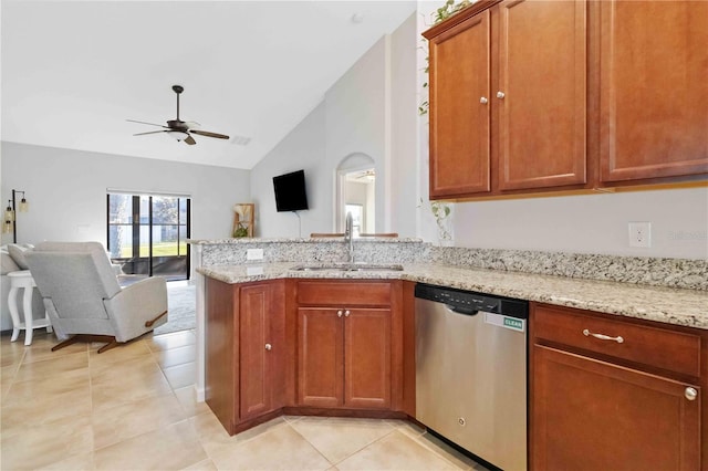 kitchen featuring lofted ceiling, sink, stainless steel dishwasher, ceiling fan, and light stone countertops