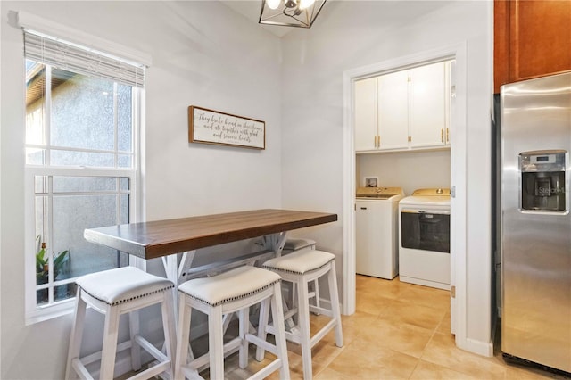 tiled dining room with washer and dryer