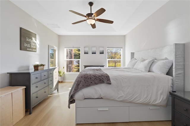 bedroom with ceiling fan and light hardwood / wood-style flooring