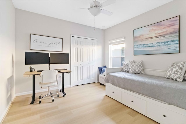 bedroom with hardwood / wood-style flooring, ceiling fan, and a closet