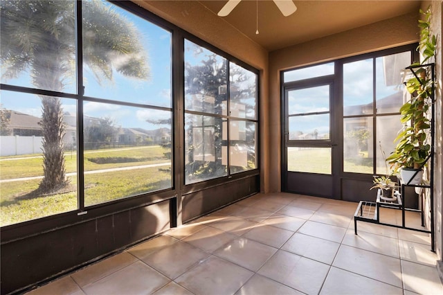 unfurnished sunroom with a healthy amount of sunlight and ceiling fan