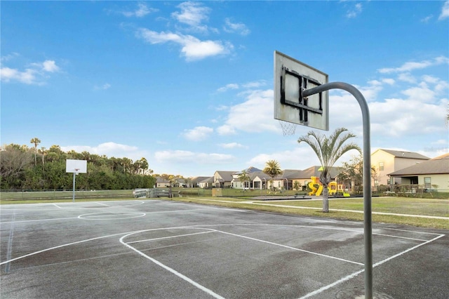 view of basketball court with a playground and a yard