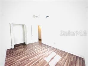 spare room with dark wood-type flooring