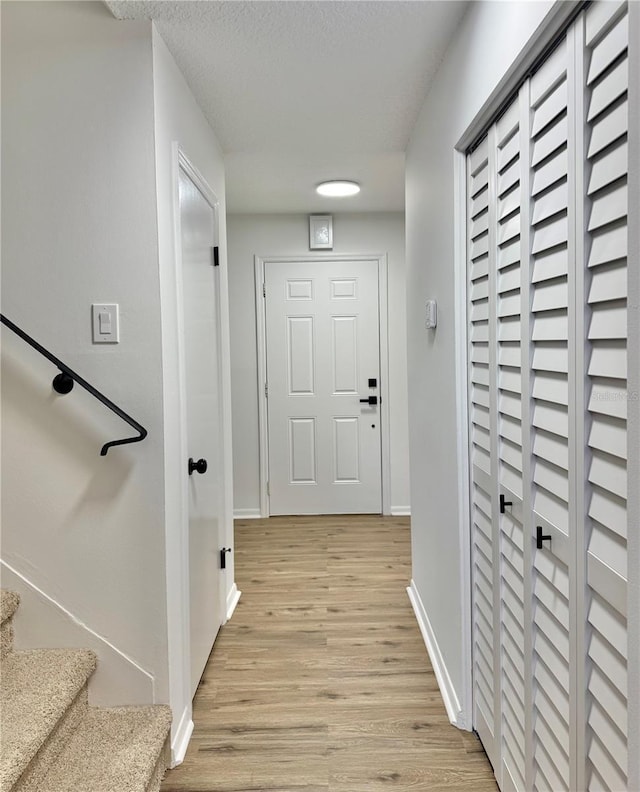 interior space featuring a textured ceiling and light hardwood / wood-style flooring