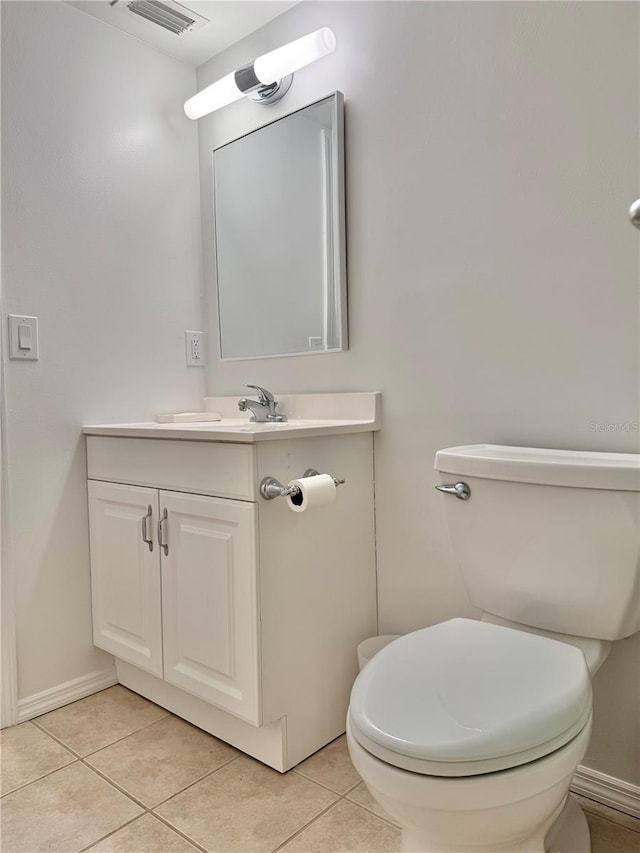 bathroom with tile patterned flooring, vanity, and toilet