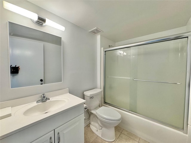 full bathroom with tile patterned flooring, vanity, enclosed tub / shower combo, and toilet