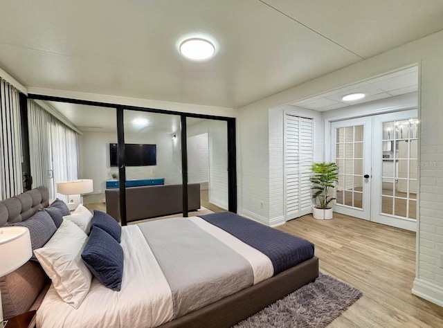 bedroom with light hardwood / wood-style flooring and french doors