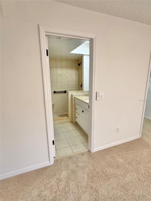 bathroom with vanity, tile patterned flooring, and a textured ceiling