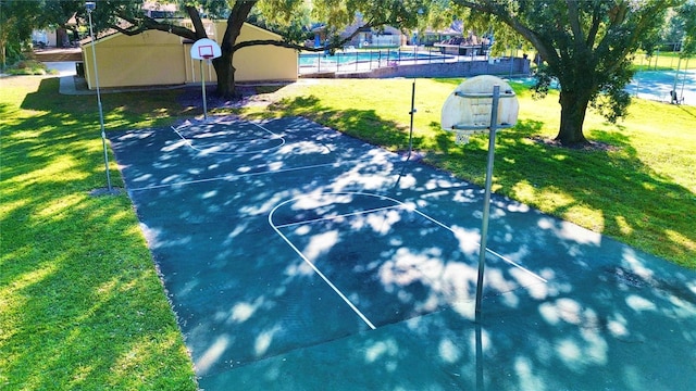 view of basketball court with a lawn