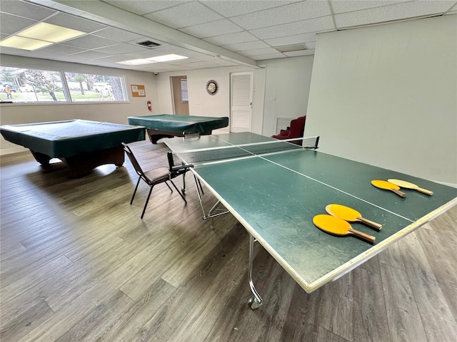 game room with a drop ceiling, pool table, and dark hardwood / wood-style floors