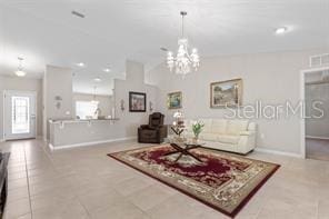 living room with tile patterned floors and a chandelier