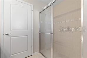 bathroom featuring a shower with door