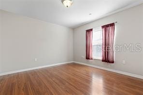 unfurnished room with wood-type flooring