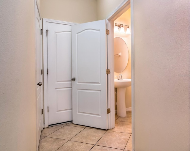 hall with light tile patterned floors