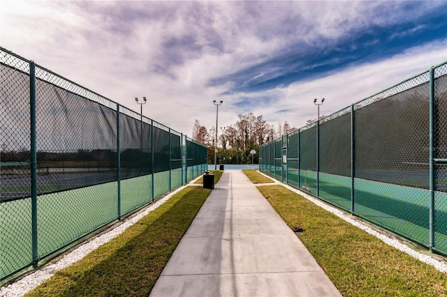 view of home's community featuring tennis court