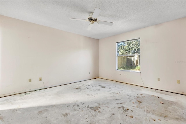 empty room featuring ceiling fan and a textured ceiling