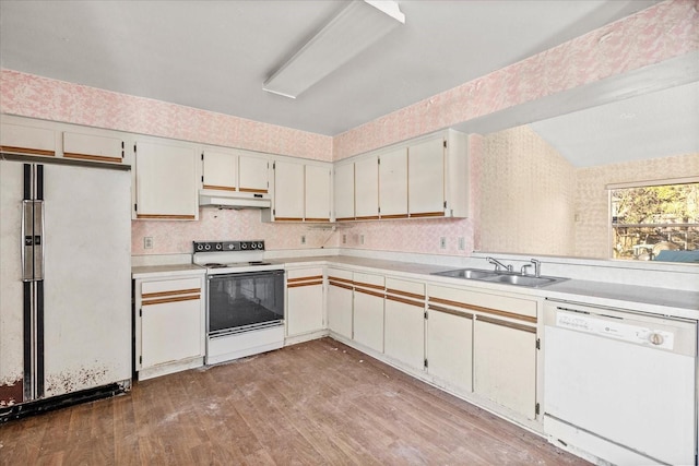 kitchen featuring sink, white appliances, white cabinets, and light wood-type flooring