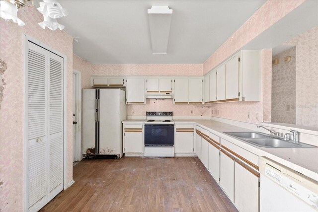 kitchen featuring white cabinetry, sink, white appliances, and light wood-type flooring