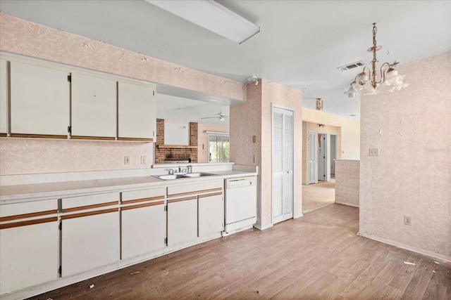 kitchen featuring white cabinetry, sink, dishwasher, and light wood-type flooring