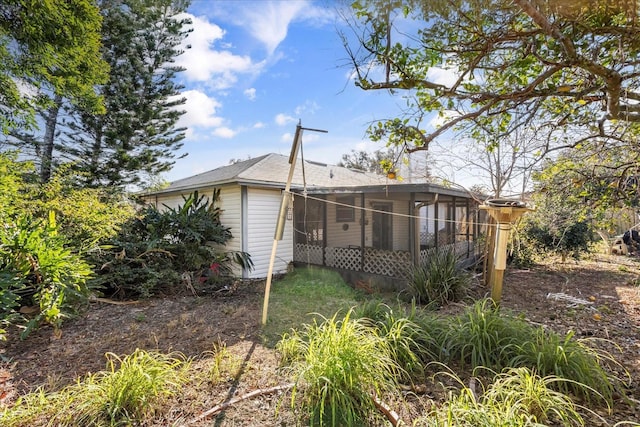 back of property with a sunroom