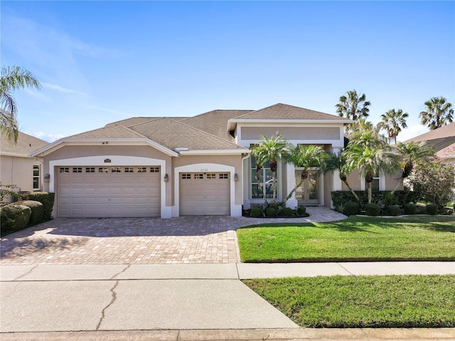 view of front of home featuring a garage and a front lawn