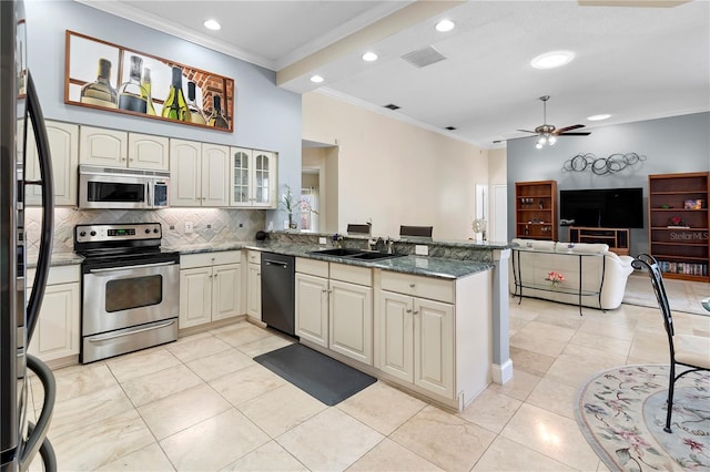 kitchen featuring sink, tasteful backsplash, crown molding, appliances with stainless steel finishes, and kitchen peninsula