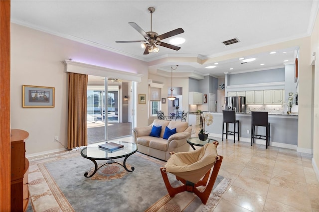 living room with ceiling fan and ornamental molding