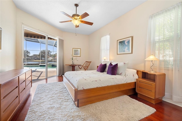 bedroom featuring dark wood-type flooring, access to exterior, and ceiling fan