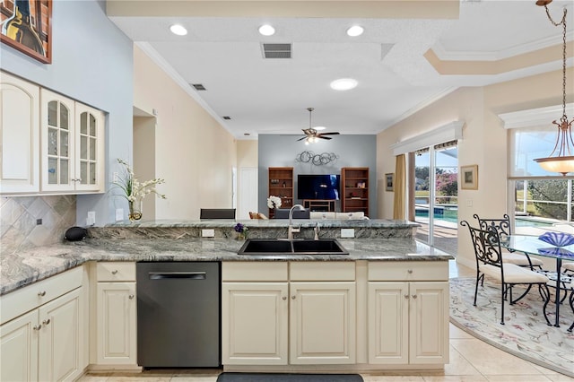 kitchen with light stone counters, sink, crown molding, and black dishwasher