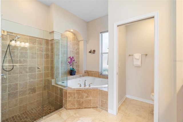 bathroom featuring toilet and separate shower and tub