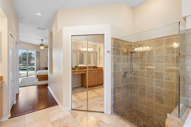 bathroom featuring vanity, tile patterned flooring, ceiling fan, and walk in shower