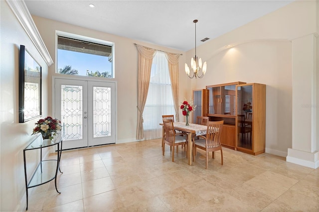 dining space with an inviting chandelier, light tile patterned floors, and french doors